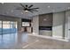 Bright living area showcasing gray floors, a contemporary fireplace, and seamless access to outdoor sliding glass doors and the kitchen at 10637 N 16Th Ave, Phoenix, AZ 85029