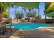 A community pool and hot tub area with sunshades and poolside seating, perfect for outdoor enjoyment and relaxation at 1075 E Chandler Blvd # 212, Chandler, AZ 85225