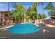 View of the community pool with a hot tub area, surrounded by shade coverings and landscaping, for resident's enjoyment at 1075 E Chandler Blvd # 212, Chandler, AZ 85225