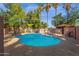 Community pool with a hot tub, surrounded by shade coverings and palm trees, offering residents a luxurious outdoor space at 1075 E Chandler Blvd # 212, Chandler, AZ 85225