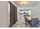 Open-concept dining area with marble floors, stylish chairs, and a view into the kitchen at 1107 E La Salle St, Phoenix, AZ 85040