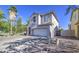 Two-story home with a two-car garage and a blue front door at 1107 E La Salle St, Phoenix, AZ 85040