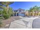 Two-story home with a well-manicured front yard and a blue front door at 1107 E La Salle St, Phoenix, AZ 85040