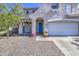 Charming front porch featuring a vibrant blue door, potted plants, and an arched entryway at 1107 E La Salle St, Phoenix, AZ 85040