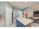 A bright kitchen featuring stone floors, stainless appliances, and a central island at 1107 E La Salle St, Phoenix, AZ 85040