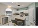 Bright kitchen featuring stone floors, stainless appliances, a breakfast bar, and lots of cabinet space at 1107 E La Salle St, Phoenix, AZ 85040