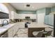 A bright kitchen with marble floors, stainless appliances, a tile backsplash, and a central island at 1107 E La Salle St, Phoenix, AZ 85040
