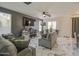 Spacious living room featuring marble floors, a large TV, and comfortable seating at 1107 E La Salle St, Phoenix, AZ 85040