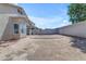 Large, empty backyard with potential for new landscaping, bordered by a block wall for added privacy at 11630 W Jefferson St, Avondale, AZ 85323