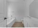 Bright bathroom featuring double sinks, a soaking tub, and modern fixtures at 11630 W Jefferson St, Avondale, AZ 85323