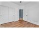 Bedroom featuring wood laminate flooring and neutral walls at 11630 W Jefferson St, Avondale, AZ 85323
