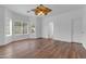 Bright bedroom with hardwood floors, a ceiling fan, and large windows overlooking the backyard at 11630 W Jefferson St, Avondale, AZ 85323