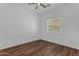 Bedroom with wood laminate flooring, ceiling fan and window with blinds at 11630 W Jefferson St, Avondale, AZ 85323