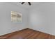 Bedroom with wood laminate flooring, ceiling fan and window with blinds at 11630 W Jefferson St, Avondale, AZ 85323