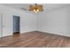 Primary bedroom boasts wood-look floors, a ceiling fan and is neutrally painted at 11630 W Jefferson St, Avondale, AZ 85323