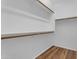 Walk-in closet with wood laminate flooring and white walls at 11630 W Jefferson St, Avondale, AZ 85323