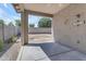 Relaxing covered patio space with concrete flooring, ideal for outdoor entertaining and enjoying the backyard view at 11630 W Jefferson St, Avondale, AZ 85323