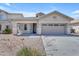 Charming single-story home featuring a two-car garage, desert landscaping, and a covered front porch at 11630 W Jefferson St, Avondale, AZ 85323