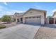 Inviting single-story home with a wide driveway, desert landscaping, and a classic architectural style at 11630 W Jefferson St, Avondale, AZ 85323