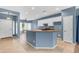 Open-concept kitchen with a center island, white cabinetry, tile flooring, and modern appliances at 11630 W Jefferson St, Avondale, AZ 85323