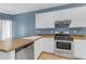 Kitchen features stainless steel dishwasher and gas range with white cabinets at 11630 W Jefferson St, Avondale, AZ 85323