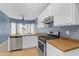 Kitchen features white cabinets, stainless steel appliances, and light-brown countertops at 11630 W Jefferson St, Avondale, AZ 85323