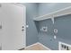 Bright laundry room with convenient shelving and utility connections, perfect for efficient home management at 11630 W Jefferson St, Avondale, AZ 85323