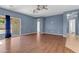 Spacious living room with hardwood floors, sliding glass door to patio, and ample natural light at 11630 W Jefferson St, Avondale, AZ 85323