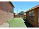 Low-maintenance backyard with artificial grass and a secure block fence for privacy at 12830 S Wakial S Loop, Phoenix, AZ 85044