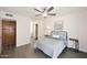Comfortable bedroom with grey wood floors, ceiling fan, closet, and neutral paint at 12830 S Wakial S Loop, Phoenix, AZ 85044
