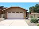 Beige stucco home exterior with a two-car garage and a well-maintained desert landscape at 12830 S Wakial S Loop, Phoenix, AZ 85044