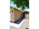 Exterior of home showing access to a walled courtyard, mature landscaping and desert rock at 12830 S Wakial S Loop, Phoenix, AZ 85044
