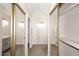 Hallway featuring updated flooring, fresh paint, sliding closet doors and bathroom access at 12830 S Wakial S Loop, Phoenix, AZ 85044