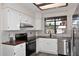 Clean and bright kitchen with white cabinets, stainless steel appliances, and wood countertops at 12830 S Wakial S Loop, Phoenix, AZ 85044
