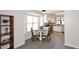 Cozy kitchen and breakfast nook with white cabinets, laminate floors, and large windows at 12830 S Wakial S Loop, Phoenix, AZ 85044