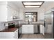 Well-lit kitchen with stainless steel appliances, white cabinets, and modern backsplash at 12830 S Wakial S Loop, Phoenix, AZ 85044