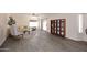 Bright living room featuring laminate floors, a large window, and sliding door access to the patio at 12830 S Wakial S Loop, Phoenix, AZ 85044