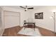 Bright home office with modern glass desk, wood-look floors and overhead lighting at 12830 S Wakial S Loop, Phoenix, AZ 85044