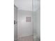Shower featuring large light gray tiles, glass door and a built-in shampoo niche at 12830 S Wakial S Loop, Phoenix, AZ 85044