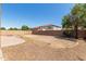 Spacious backyard featuring a brick firepit and ample room for various outdoor activities and landscaping at 13617 W Crocus Dr, Surprise, AZ 85379