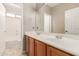 Bathroom with a double sink vanity, a large mirror, and a separate tub and shower area at 13617 W Crocus Dr, Surprise, AZ 85379
