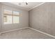 Cozy bedroom featuring a window, neutral walls, carpeted floor, and a minimalist design at 13617 W Crocus Dr, Surprise, AZ 85379