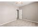 Cozy bedroom with carpet, fan and natural light, features a closet and en-suite bathroom at 13617 W Crocus Dr, Surprise, AZ 85379