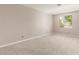 Bedroom featuring plush carpeting, neutral walls, and a bright window at 13617 W Crocus Dr, Surprise, AZ 85379
