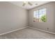 Carpeted bedroom with ceiling fan, natural light and neutral paint provides an inviting space at 13617 W Crocus Dr, Surprise, AZ 85379