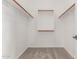 Walk-in closet with carpet and built-in shelves and racks provides ample storage space at 13617 W Crocus Dr, Surprise, AZ 85379
