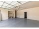 Garage featuring a finished floor, overhead storage, and access to an exterior door at 13617 W Crocus Dr, Surprise, AZ 85379