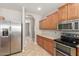 Well-appointed kitchen features modern stainless steel appliances and wood cabinetry for efficient meal preparation at 13617 W Crocus Dr, Surprise, AZ 85379