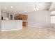 Open concept kitchen with wood cabinets, a breakfast bar, and stainless steel appliances at 13617 W Crocus Dr, Surprise, AZ 85379
