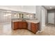 Kitchen with a breakfast bar, stainless steel appliances, and wood cabinets in neutral tones at 13617 W Crocus Dr, Surprise, AZ 85379